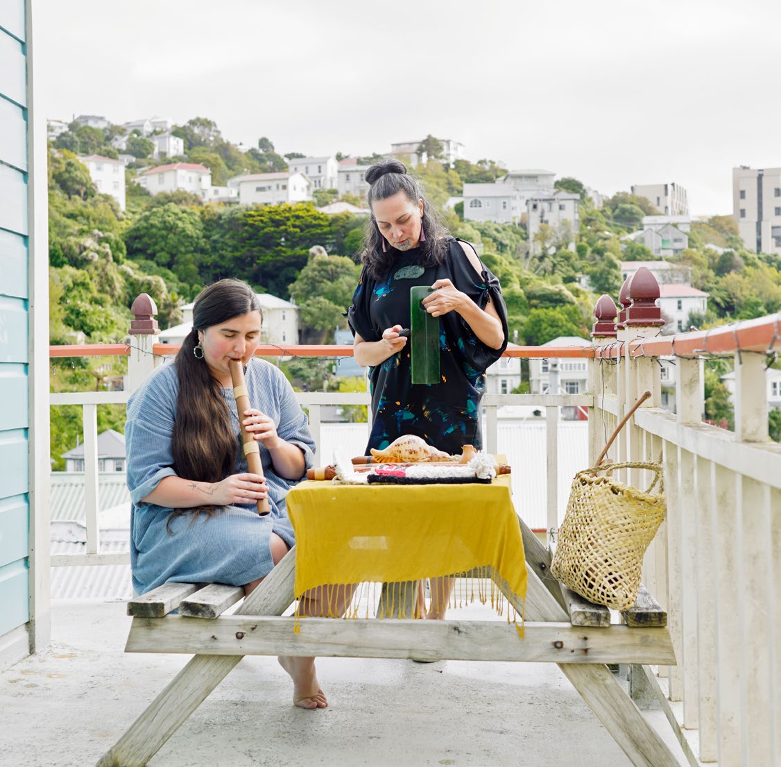 Ruby Solly (left) plays a pūmotomoto, while Ariana Tikao plays a pahu pounamu.