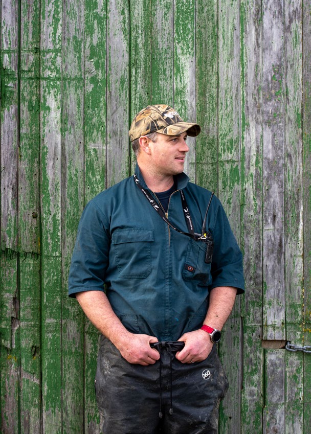 Spencer-Bower standing in front of the original farm shed.