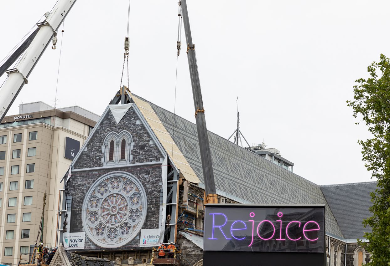 Cranes placing ChristChurch Cathedral’s temporary canvas front.