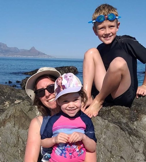 Claire with her children at the beach in South Africa.