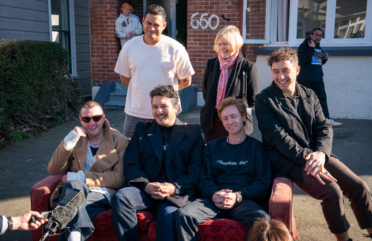 Six60 band members in front of the flat where they first formed. Photo: University of Otago.