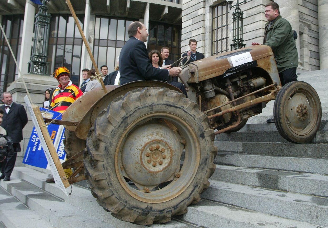 Former National MP Shane Ardern driving a tractor up Parliament steps during the anti-fart tax protest by farmers in September 2003. Photo: New Zealand Herald.