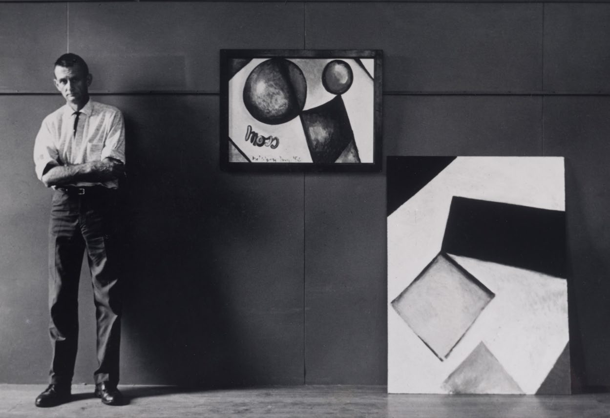 Colin McCahon with paintings